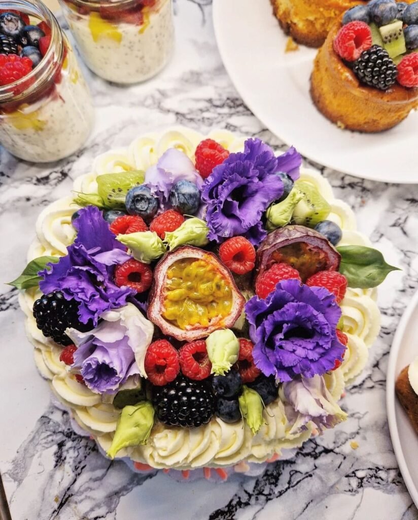A Cake with fruit all over it