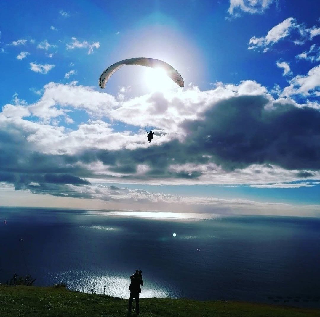 image of madeiras bluee skys paragliding over the ocean