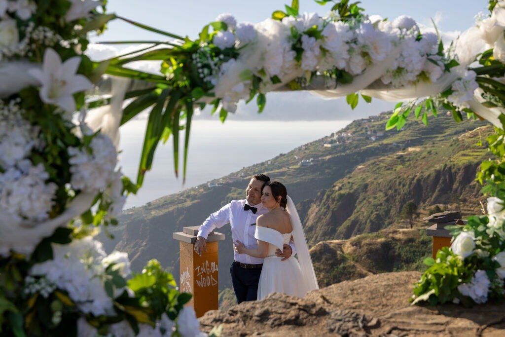 couple under a wedding arch in Madeira